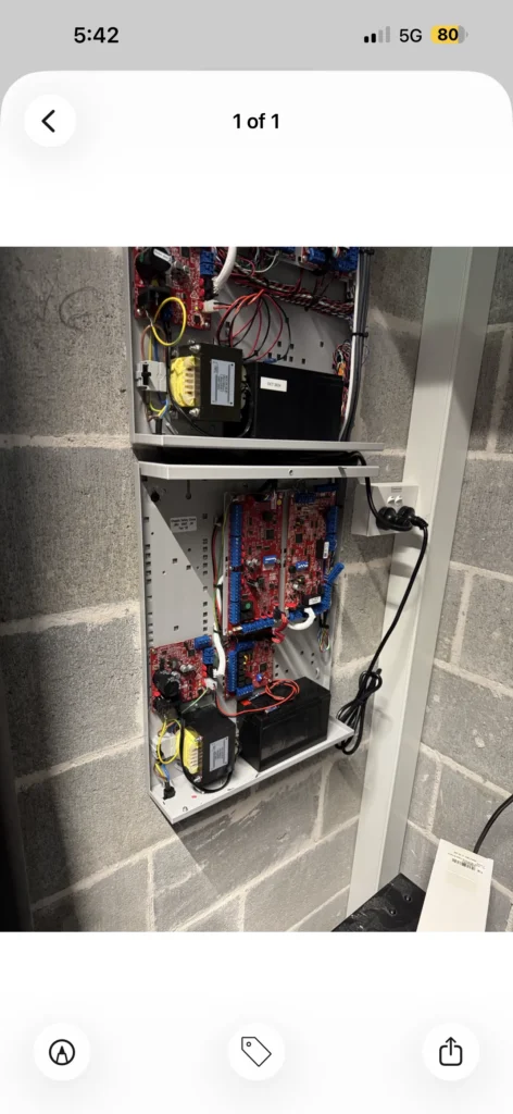 Alarm system control board installed inside a wall-mounted enclosure