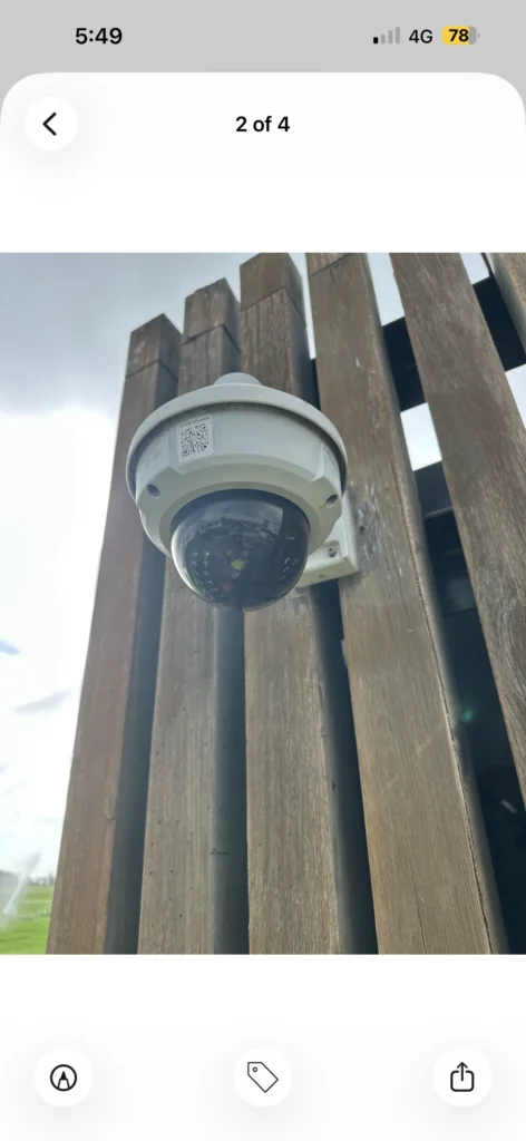 HD dome security camera mounted on a timber-slat wall
